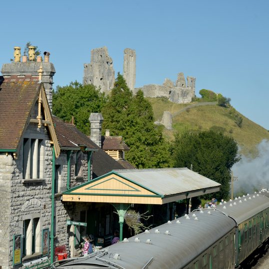 View of Corfe Castle in the Purbeck Hills of Dorset seen from West Hill